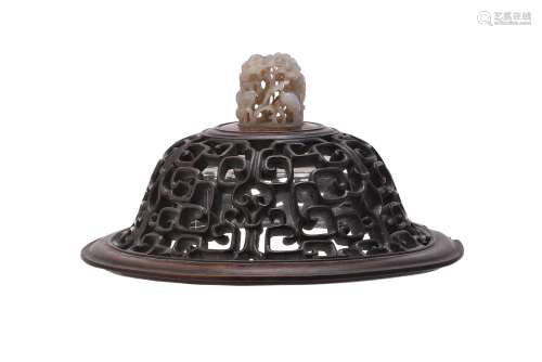 A Chinese carved hardwood cover with jade finial