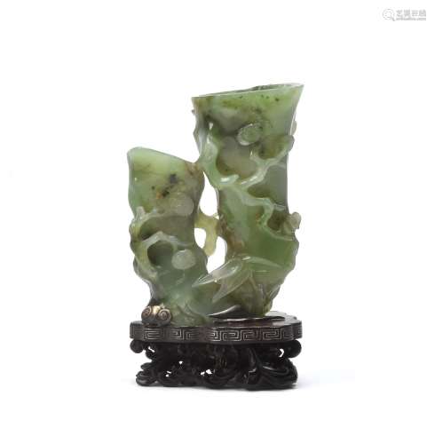 An unusual Chinese pale spinach green jade 'pine and prunus' vase