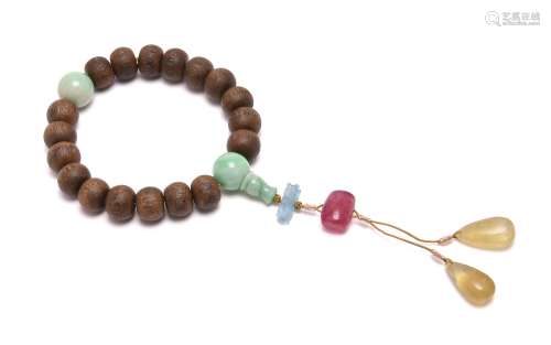A Chinese aloeswood and jadeite rosary bracelet