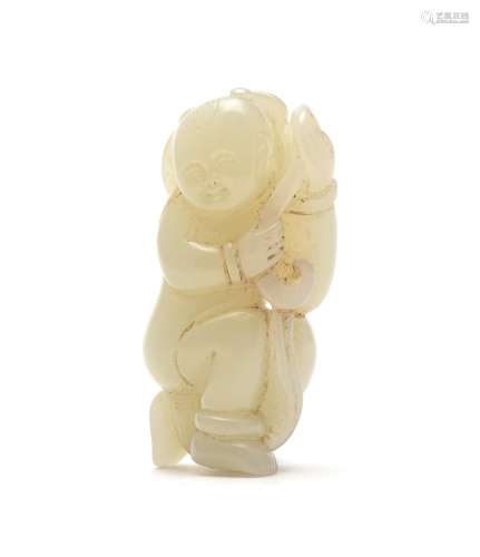 A Chinese pale celadon carving of a boy holding a Lotus Stalk