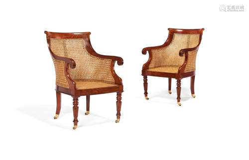 A pair of exotic hardwood and canework library armchairs in George IV style