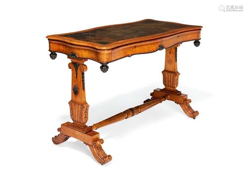 An early Victorian bird's-eye maple and parcel ebonised writing table