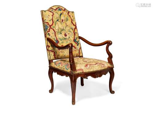 A French walnut and tapestry upholstered open armchair in Louis XV style