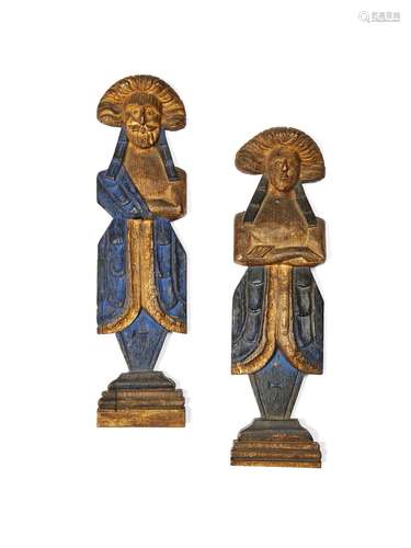 A pair of painted and parcel gilt oak figural furniture mounts in late 17th century style