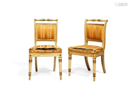 A pair of late George III white painted and parcel giltwood side chairs