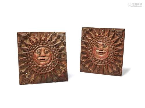 A pair of Northern European relief carved and parcel painted softwood wall plaques