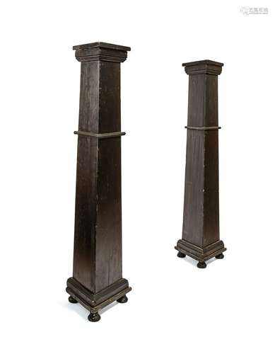 A pair of ebonised pedestals