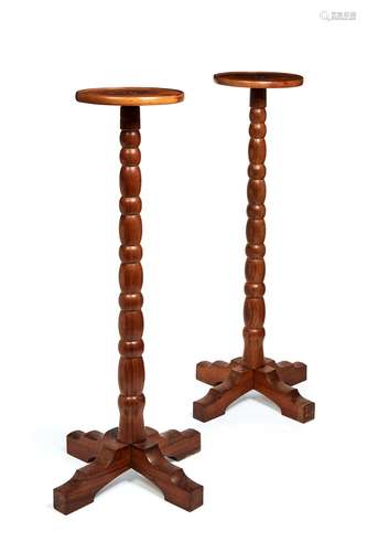 A pair of walnut torchere stands