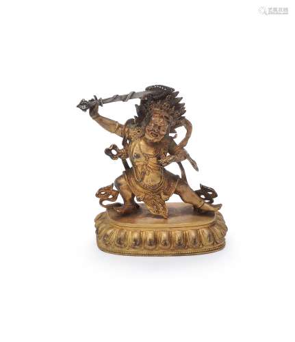 A Sino-Tibetan gilt-bronze figure of Dharmapala