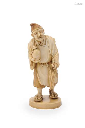 Y A Japanese Ivory Okimono carved as an elderly man wearing a soft hat and standing on an oval base