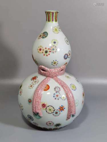 A gourd bottle with pink ball flowers