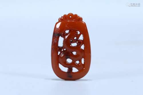 A CHINESE AMBER ORNAMENT WITH DRAGON PATTERN
