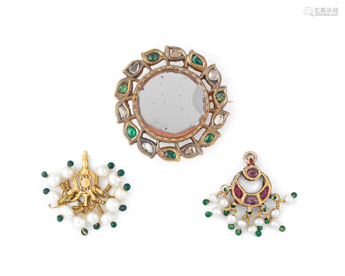 A gem-set gold forehead pendant (chand-tikka), a gem-set gold mirrored roundel and a pearl-mounted gold pendant from the collection of Maharani Jindan Kaur (1817-63), wife of Maharajah Ranjit Singh, and latterly in the possession of her granddaughter Princess Bamba Sutherland (1869-1957) Punjab, probably Lahore, first half of the 19th Century (3)