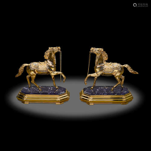 Two silver-gilt horses with sapphire eyes