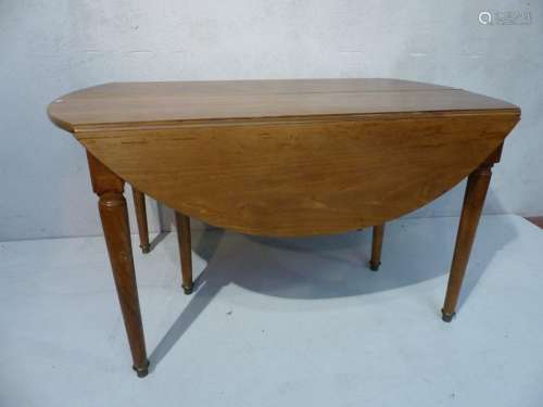 Round walnut table with extension and folding end.…