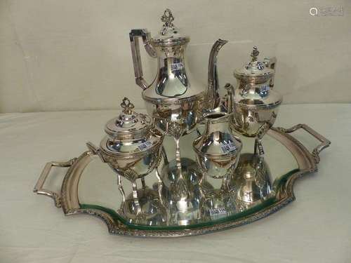 A tea and coffee set with a silver metal tray. Gol…