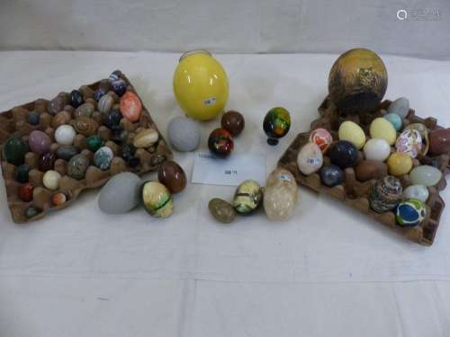 A collection of decorative eggs made of marble, va…