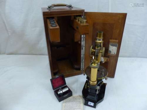 A microscope in its mahogany case.
