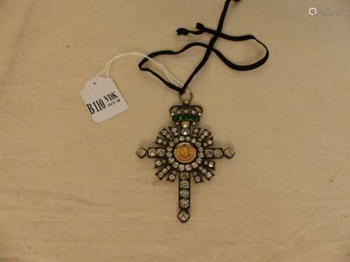 A silver cross set with stones and agglomerate. Pe…