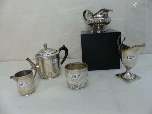 A three piece English silver tea set. Two milk jug…