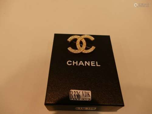 Chanel brooch with strass and silver plated metal.…