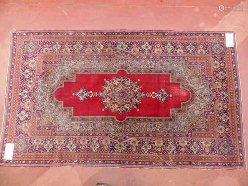 A woollen rug with floral decoration and red centr…