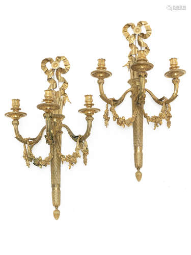 A pair of gilt bronze three-light wall appliques in the Louis XVI style,