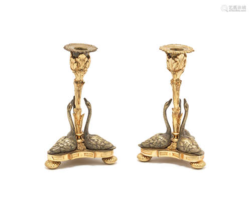 A pair of early Victorian silvered and parcel gilt swan candlesticks after a design by William Bateman II for Rundell, Bridge and Rundell