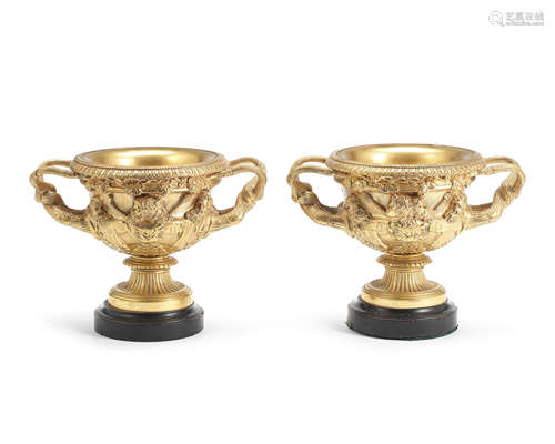 A pair of 19th century gilt bronze garniture urns cast as models of the Warwick vases