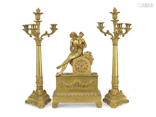 An early 19th century French matched gilt bronze figural clock garniture