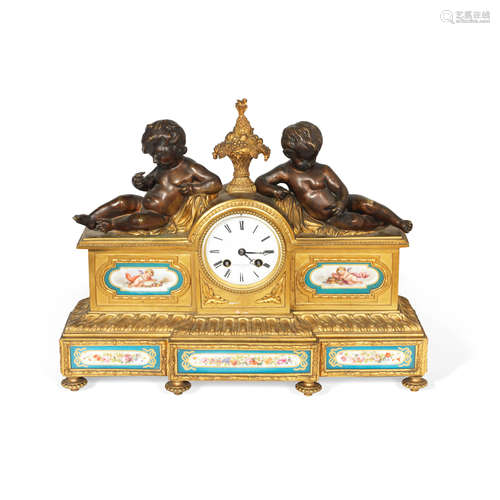 A late 19th century French gilt and patinated bronze and serves style porcelain inset figural mantel clock the dial signed Grignon-Meusnier a Paris