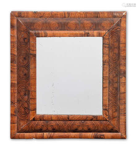 A William and Mary olivewood, oyster veneered 'cushion frame' mirror