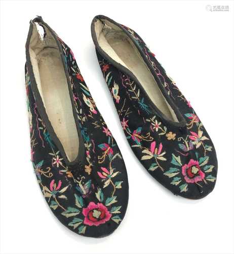 A pair of Chinese silk embroidered black slippers, with birds and trailing foliage, length 25cm.