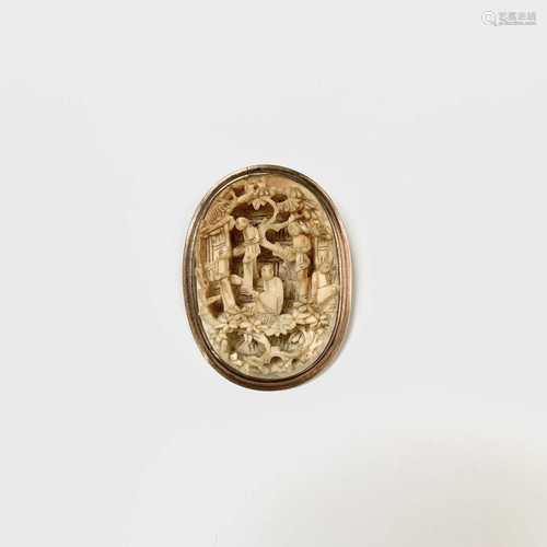 A Chinese Canton carved ivory oval brooch, within a gold mount, 4.5 x 3.5cm.