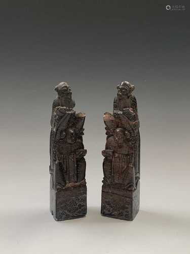 A pair of Chinese soapstone bookends, early 20th century, carved with dowest figure and attendant,