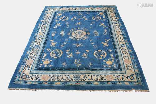 A Chinese Peking carpet, the indigo field with a central circular medallion enclosing a dragon,