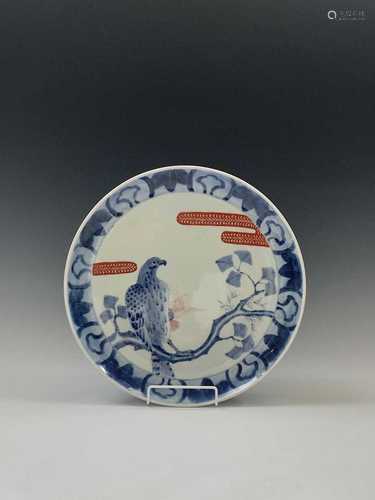 A Japanese porcelain charger, early 20th century, with a bird of prey perched on a branch,