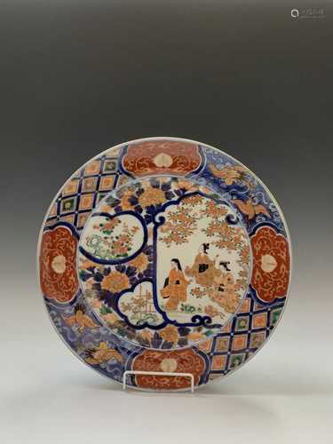 A Japanese Imari charger, late 19th century, with three Geisha girls, trees and flowers, the