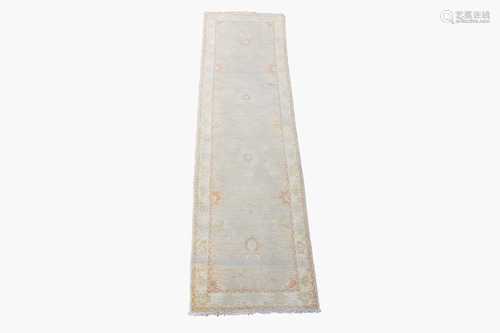 An Afghan Ziegler style runner, the beige field with central palmettes, within an ivory floral