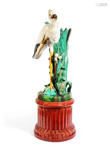 A late 19th century Majolica glazed earthenware stork stick stand and pedestal in the Minton style