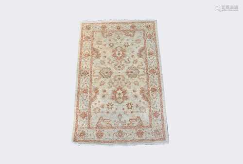 An Afghan Ziegler style rug, the ivory field with palmettes and floral sprays, within a beige