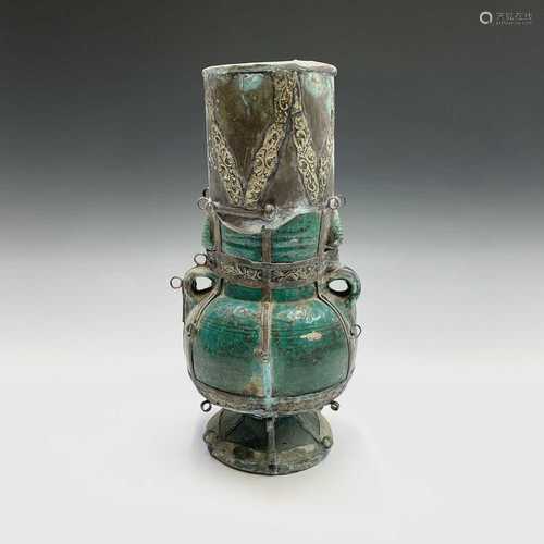 A Middle Eastern green lustre pottery vase, 19th century, with metal mounts, height 36cm.