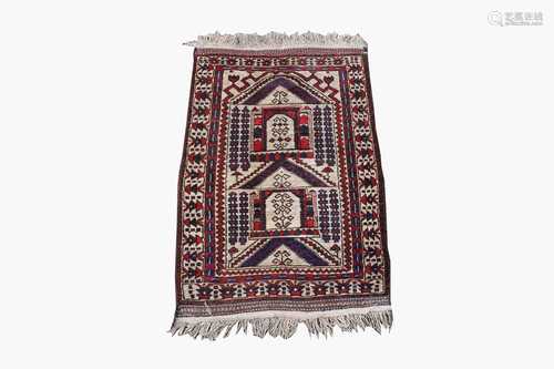 A Belouch prayer rug, the polychrome mihrab with hooked guls and motifs, within an ivory