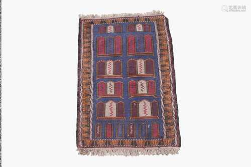 An Afghan Belouch rug, the indigo field with rows of polychrome motifs within a camel hooked gul