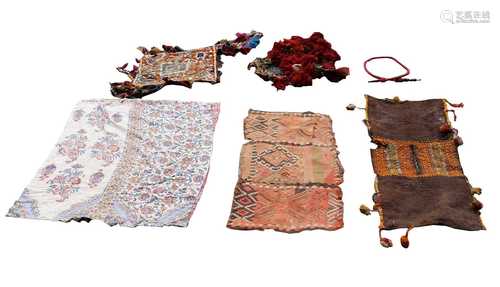 A quantity of eastern textiles to include a Turkish kelim fragment, a saddle bag, etc.