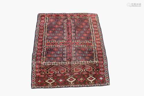 A Turkoman Hatchli rug, the quartered field with central mihrab and serrated guls, within a madder