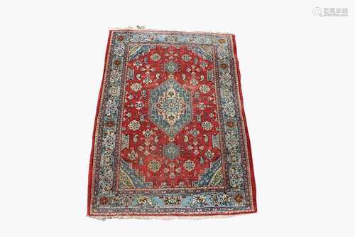 A Tabriz rug, North West Persia, the madder field with a sky blue and ivory central medallion,