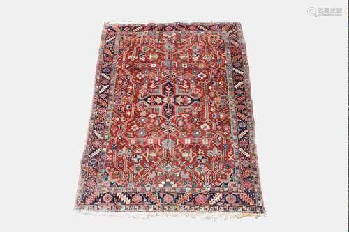 A Heriz rug, North West Persia, the madder field with a central polychrome lobed medallion,