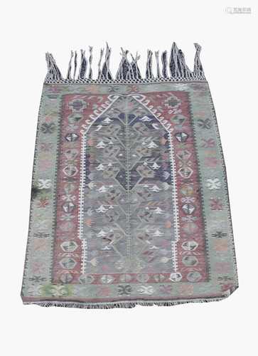 A Turkish prayer kelim, the madder field with an indigo mihrab with flowering vines and leaves,