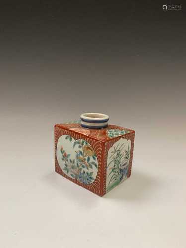 A Japanese porcelain inkwell, 19th century, of rectagular form, the white ground cartouches each